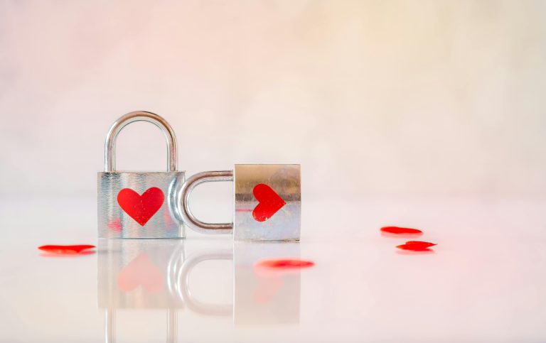 Two silver padlocks with heart designs symbolize love and connection.